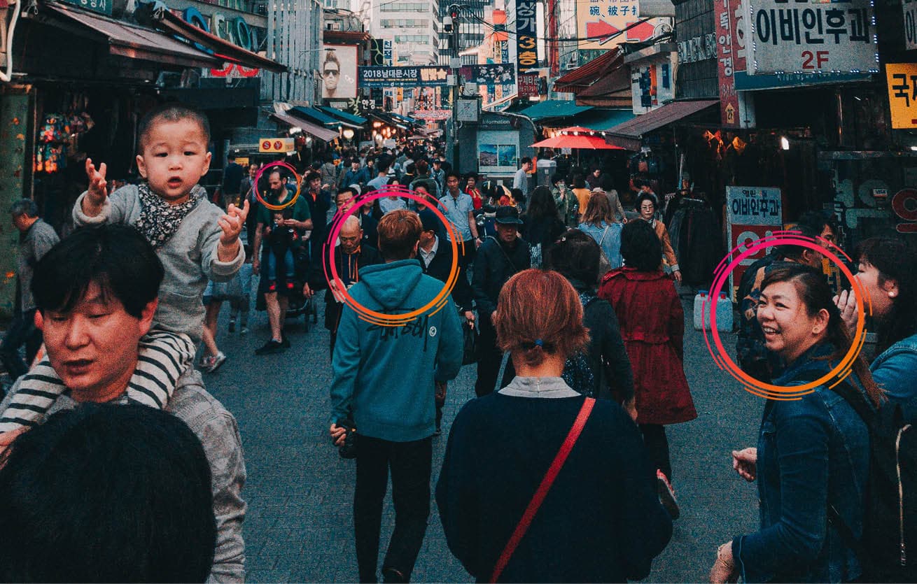Busy shopping street with individual people highlighted by Bidmath circles