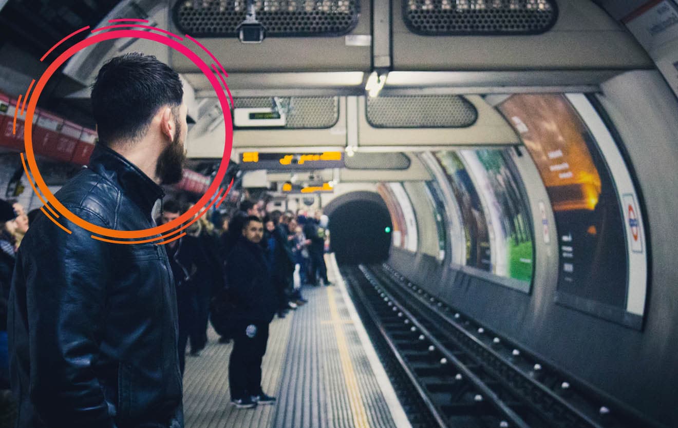 Commuter on an underground platform highlighted by the Bidmath circle