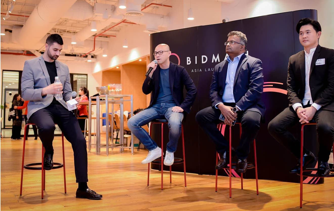 Four panellists on stage at a Bidmath panel discussion