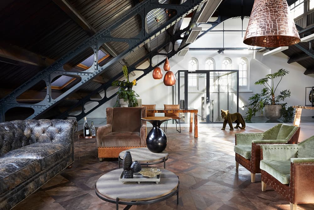 Lounge with leather sofas under an industrial staircase