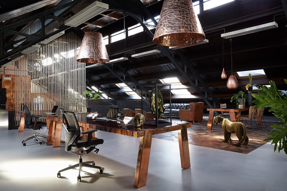 Workspace with long desks and copper pendant lights